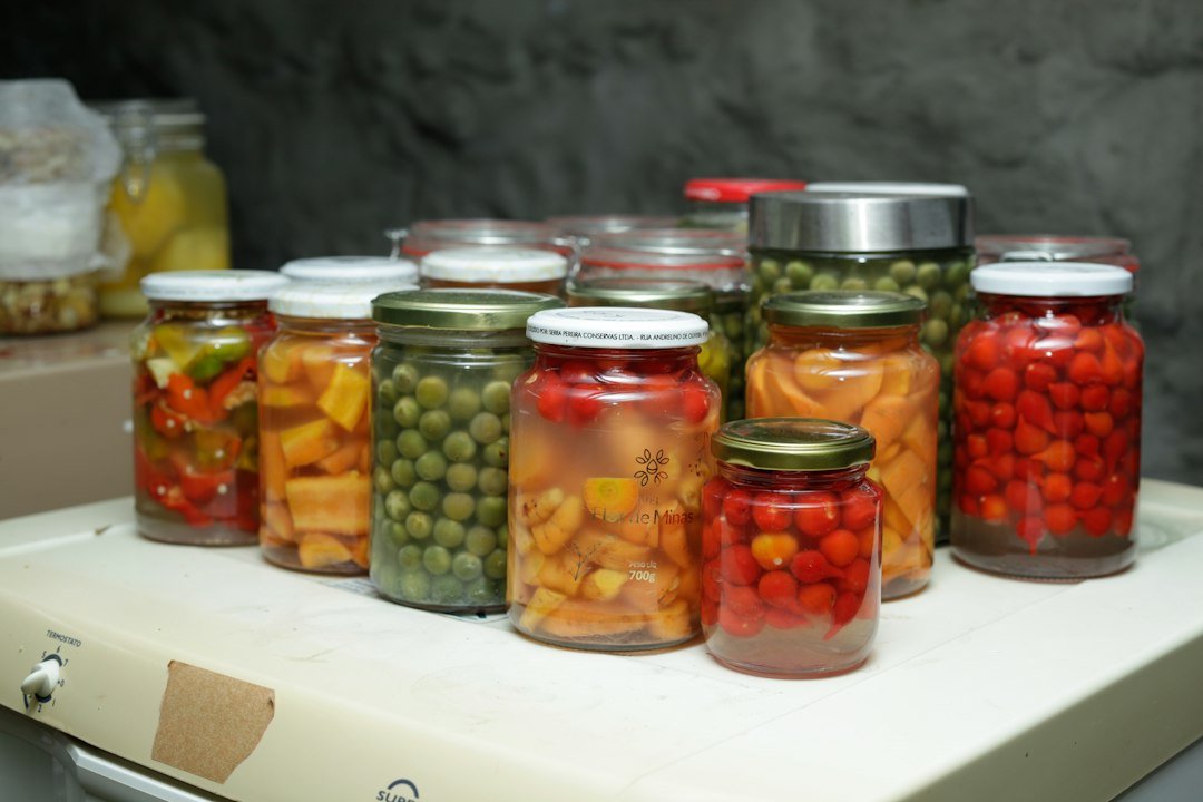 Jars of preserved vegetables and fruits on a shelf