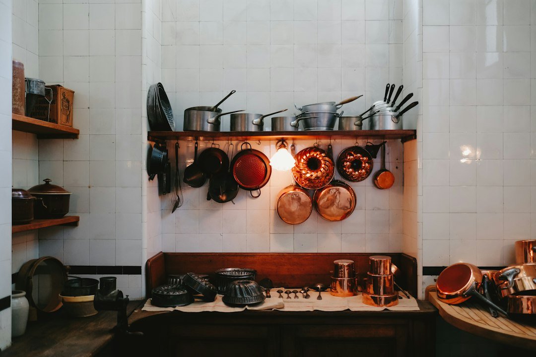 a kitchen with pots and pans hanging on the wall